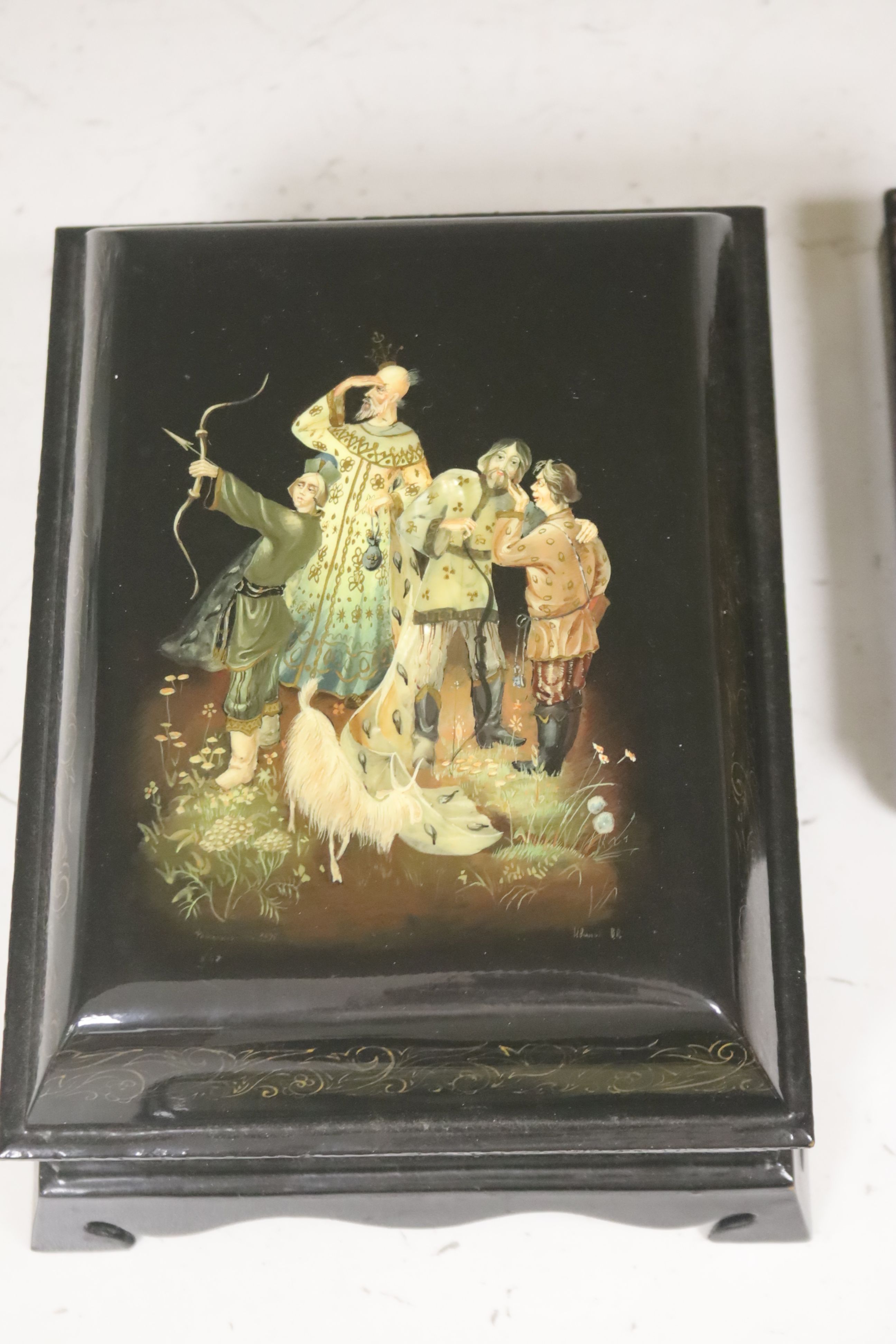 A collection of seven Russian painted lacquer boxes, largest raised on bracket base 15 x 20cm 9.5cm high